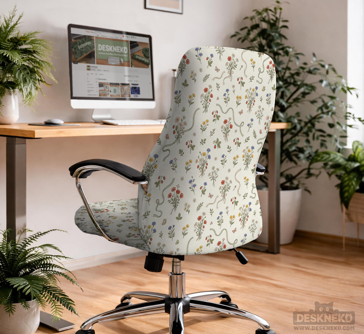 Cream chair cover with a scattered cottage garden floral print in red, blue, yellow, and green on a light background.