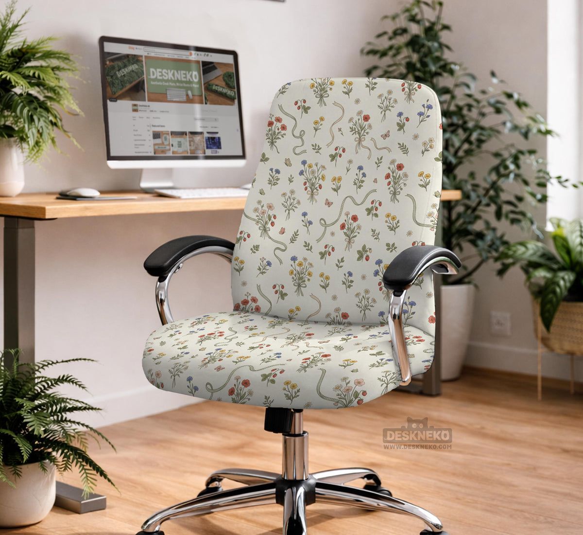 Cream chair cover with a scattered cottage garden floral print in red, blue, yellow, and green on a light background.