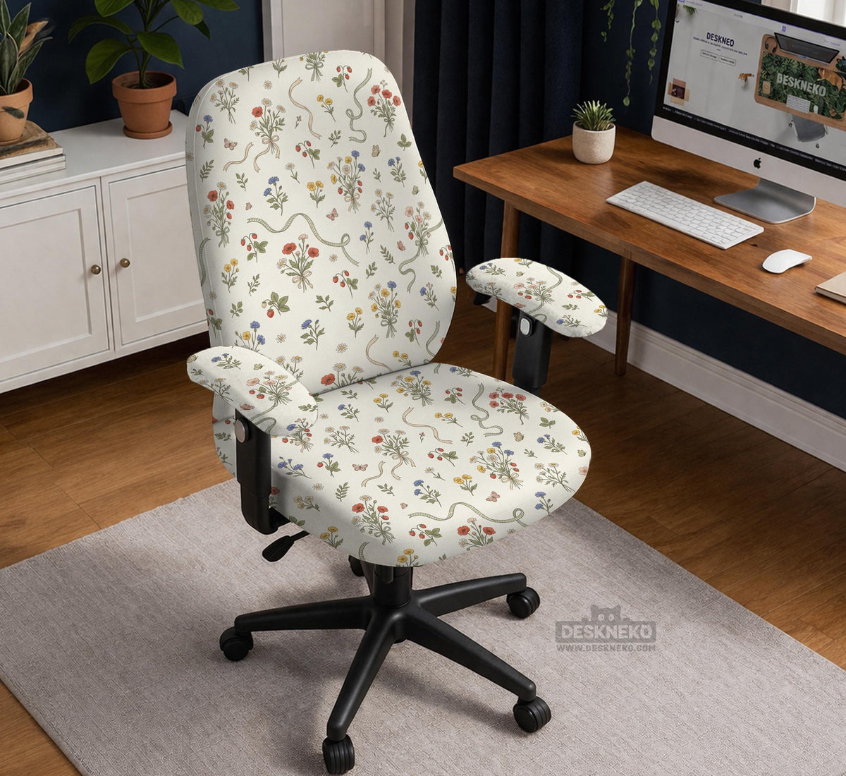 Cream chair cover with a scattered cottage garden floral print in red, blue, yellow, and green on a light background.