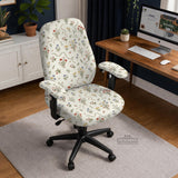 Cream chair cover with a scattered cottage garden floral print in red, blue, yellow, and green on a light background.