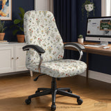 Cream chair cover with a scattered cottage garden floral print in red, blue, yellow, and green on a light background.
