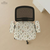 Cream chair cover with a scattered cottage garden floral print in red, blue, yellow, and green on a light background.
