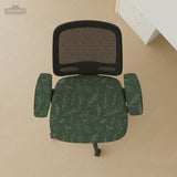 A forest green chair cover with a sage green leaf print shown on a high-back office or gaming chair.
