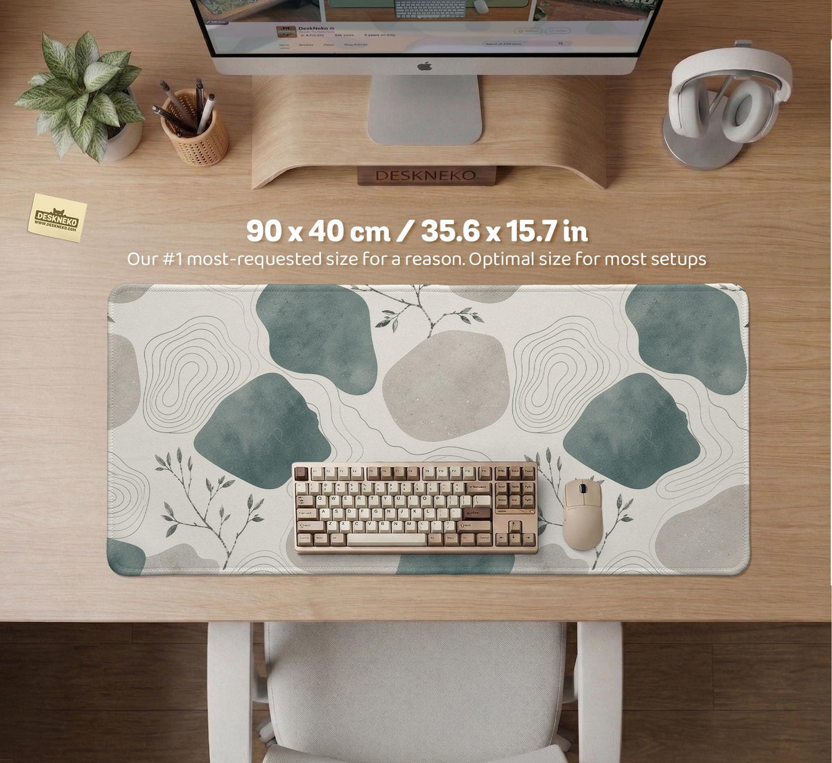 A desk mat with sage green abstract blocks, cream space, gray stone-like shapes, fine topographic contour lines, and small branch details.