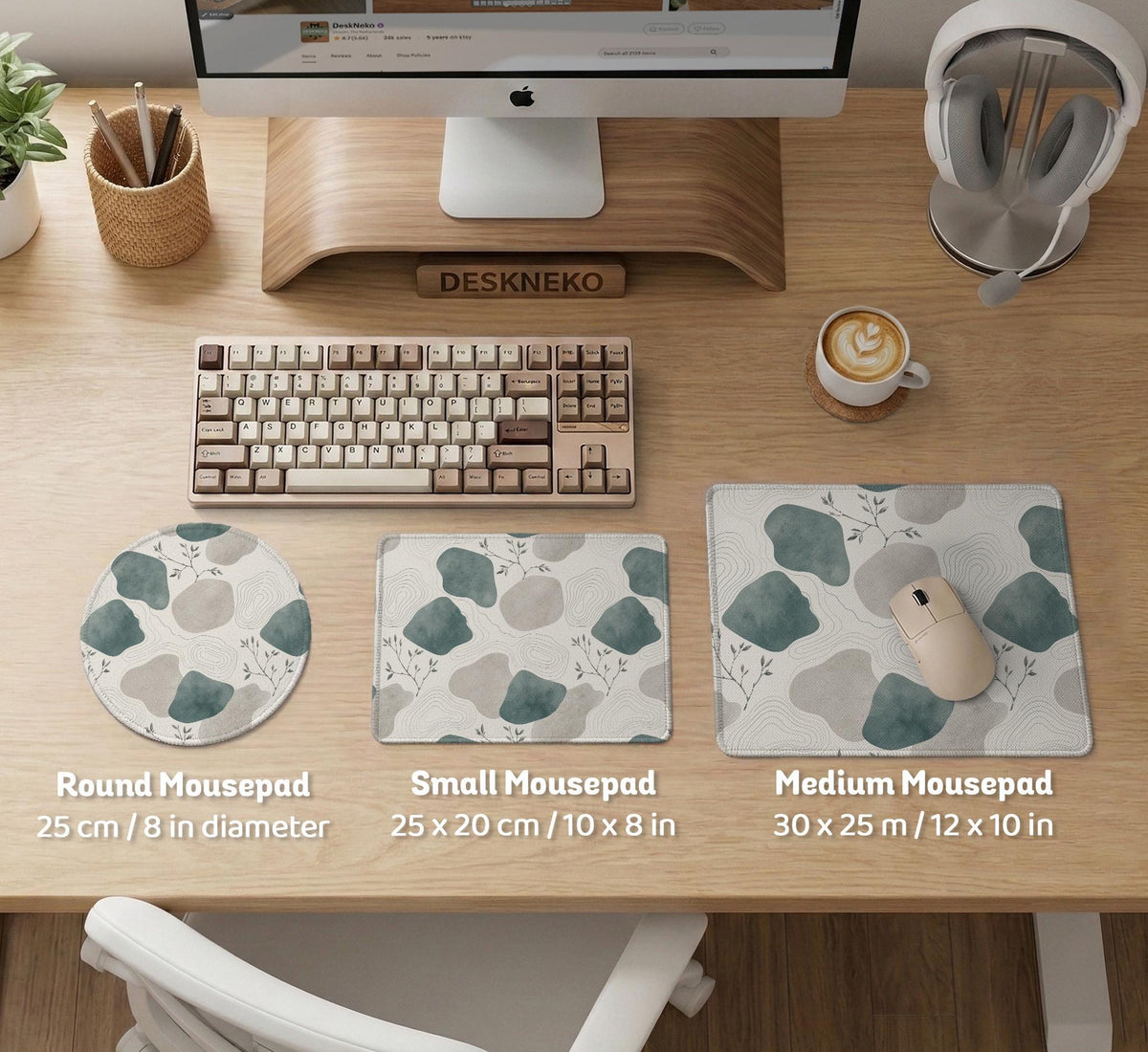A desk mat with sage green abstract blocks, cream space, gray stone-like shapes, fine topographic contour lines, and small branch details.
