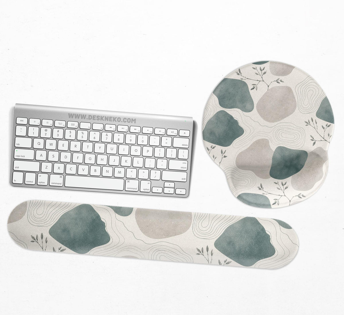 Sage green ergonomic mousepad and keyboard wrist rest with abstract shapes, soft gray details, cream space, topographic contour lines, and leafy branch accents.