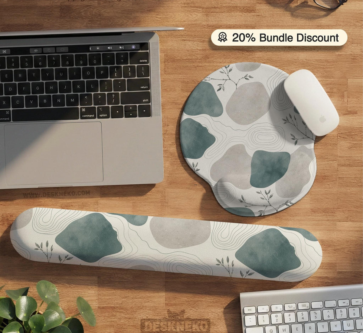 Sage green ergonomic mousepad and keyboard wrist rest with abstract shapes, soft gray details, cream space, topographic contour lines, and leafy branch accents.