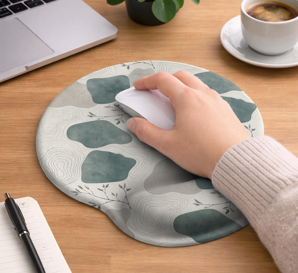 Sage green ergonomic mousepad and keyboard wrist rest with abstract shapes, soft gray details, cream space, topographic contour lines, and leafy branch accents.