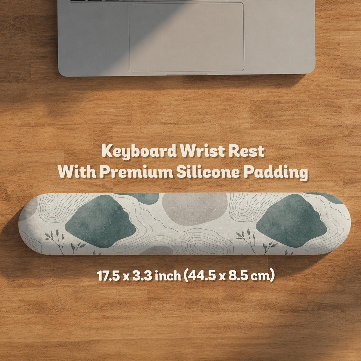 Sage green ergonomic mousepad and keyboard wrist rest with abstract shapes, soft gray details, cream space, topographic contour lines, and leafy branch accents.
