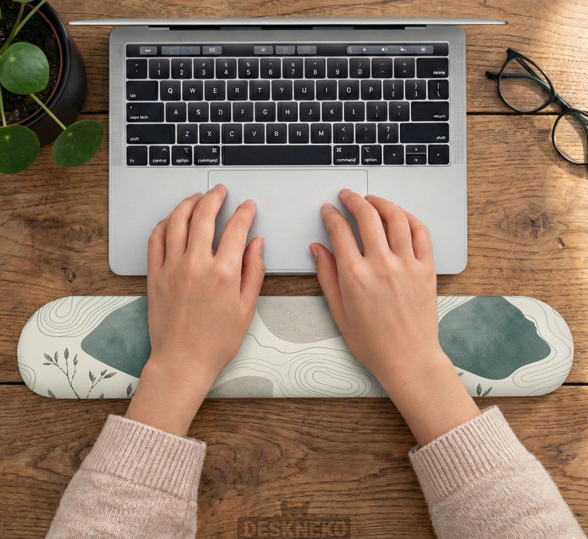 Sage green ergonomic mousepad and keyboard wrist rest with abstract shapes, soft gray details, cream space, topographic contour lines, and leafy branch accents.