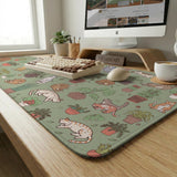 A desk mat with a repeating pattern of cats, leafy houseplants, cactus pots, and small plant-shop style details in sage green.