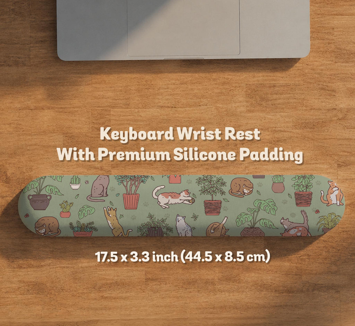 A desk mat with a repeating pattern of cats, leafy houseplants, cactus pots, and small plant-shop style details in sage green.