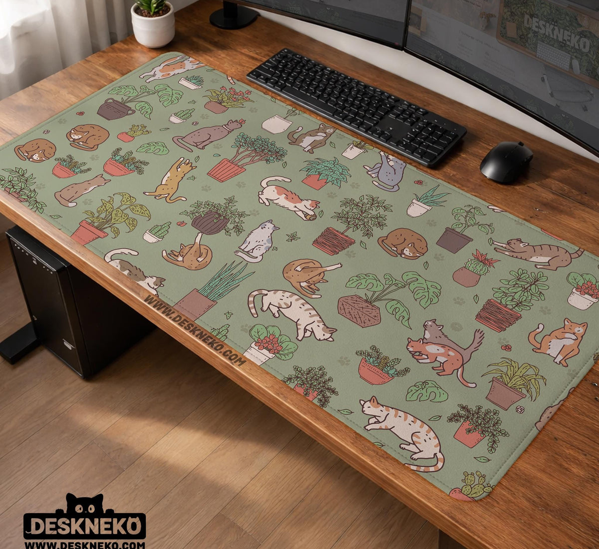 A desk mat with a repeating pattern of cats, leafy houseplants, cactus pots, and small plant-shop style details in sage green.