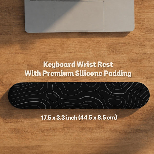 Black desk mat with a thin gray topographic contour line pattern.