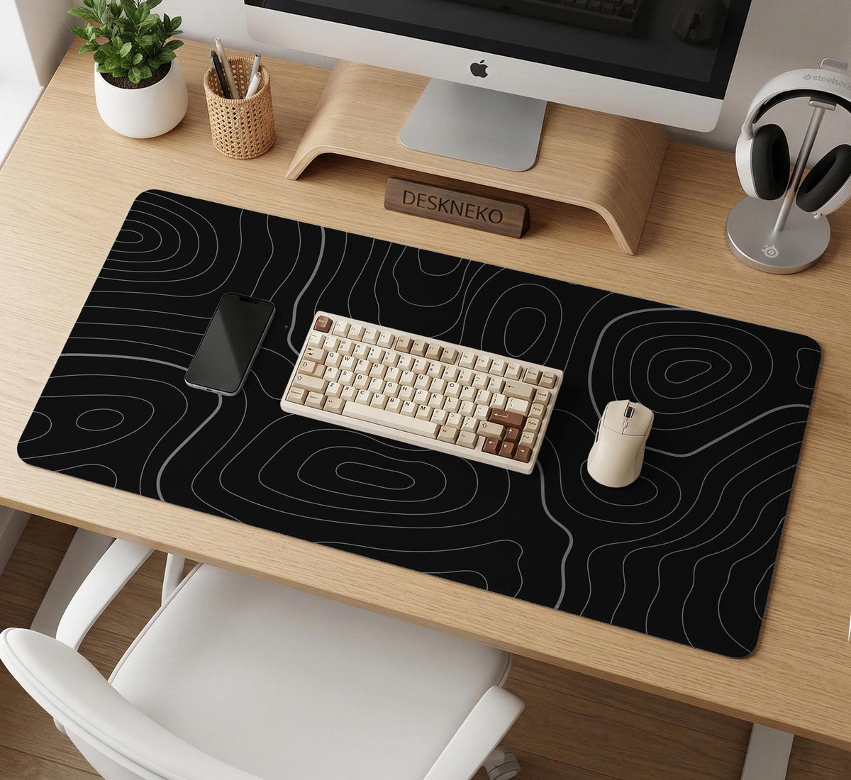 Black desk mat with a thin gray topographic contour line pattern.