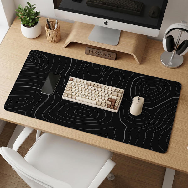 Black desk mat with a thin gray topographic contour line pattern.