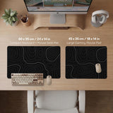 Black desk mat with a thin gray topographic contour line pattern.