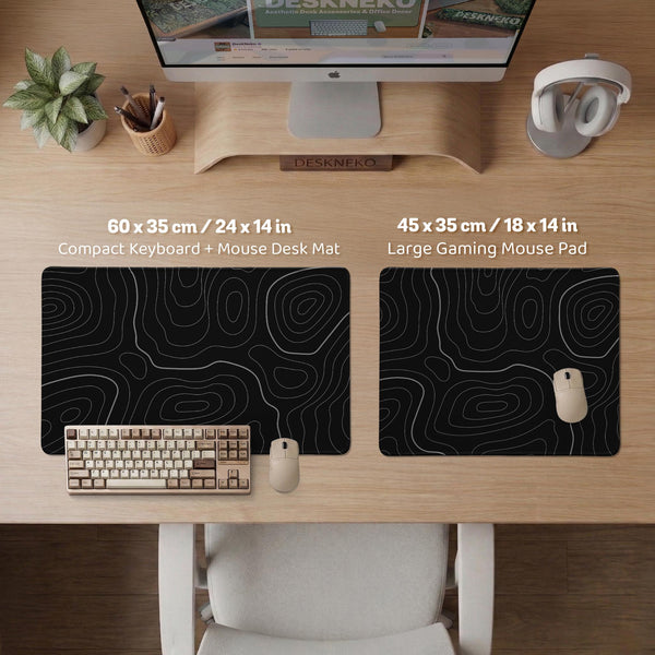 Black desk mat with a thin gray topographic contour line pattern.