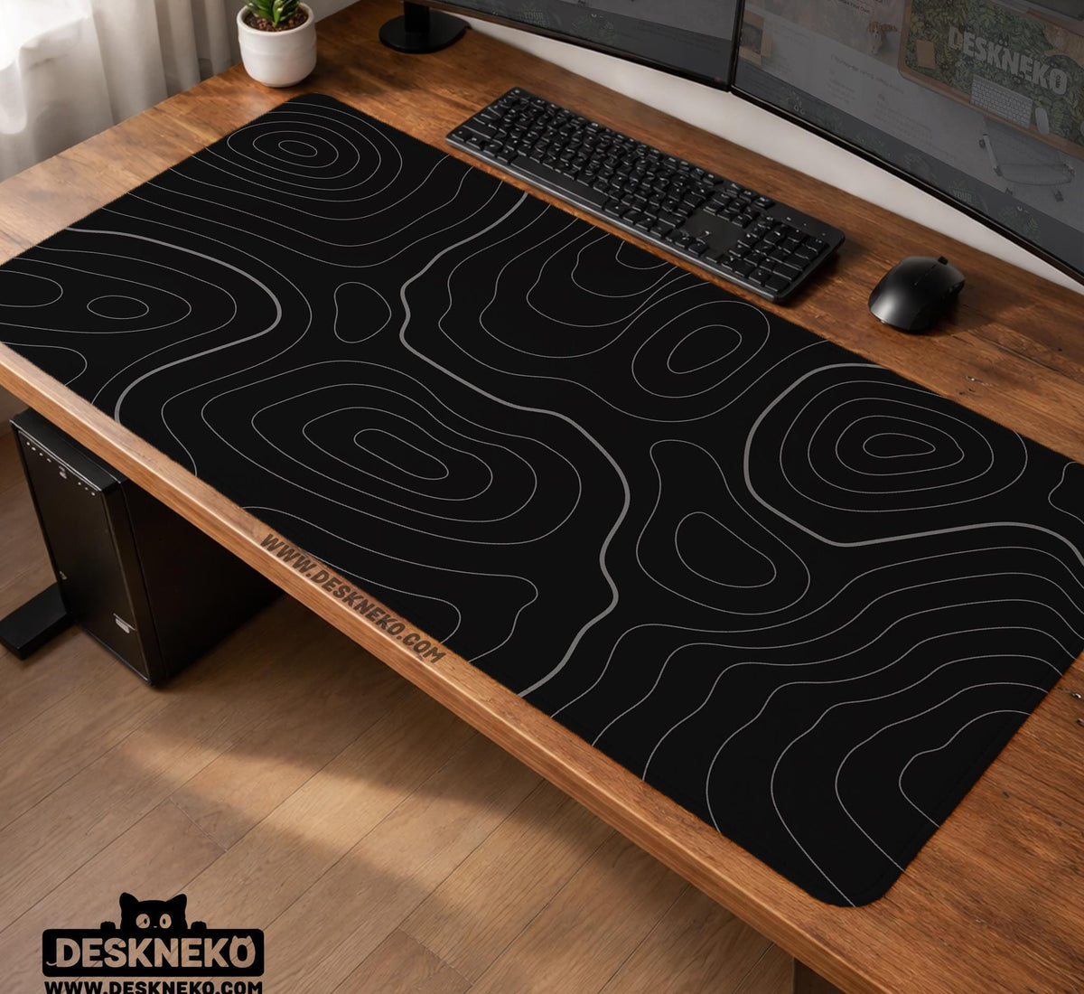 Black desk mat with a thin gray topographic contour line pattern.