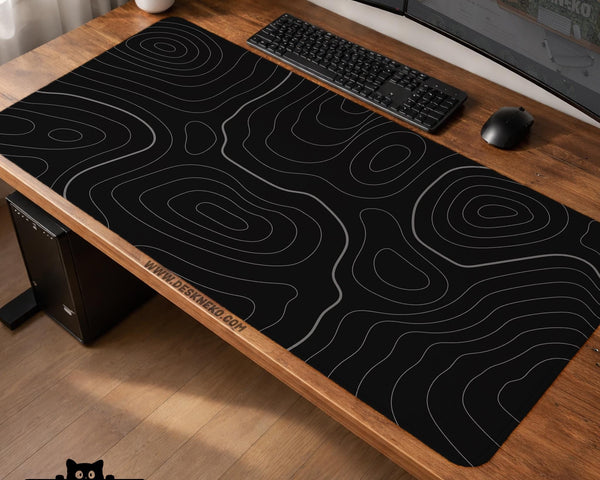 Black desk mat with a thin gray topographic contour line pattern.