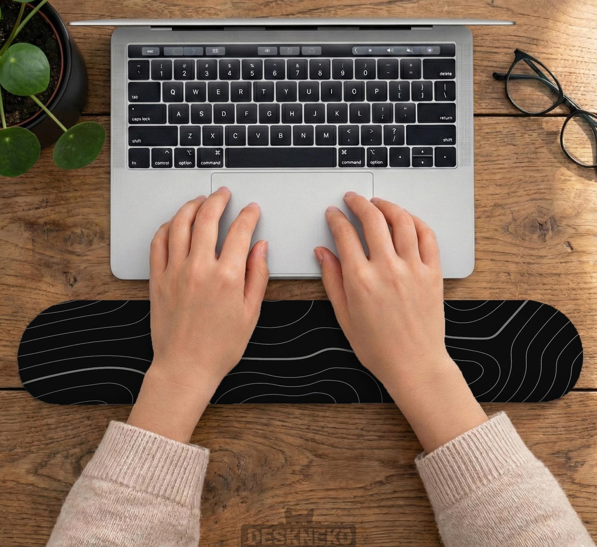 Black mousepad with a gray topographic contour line pattern shown with matching keyboard wrist rest options.