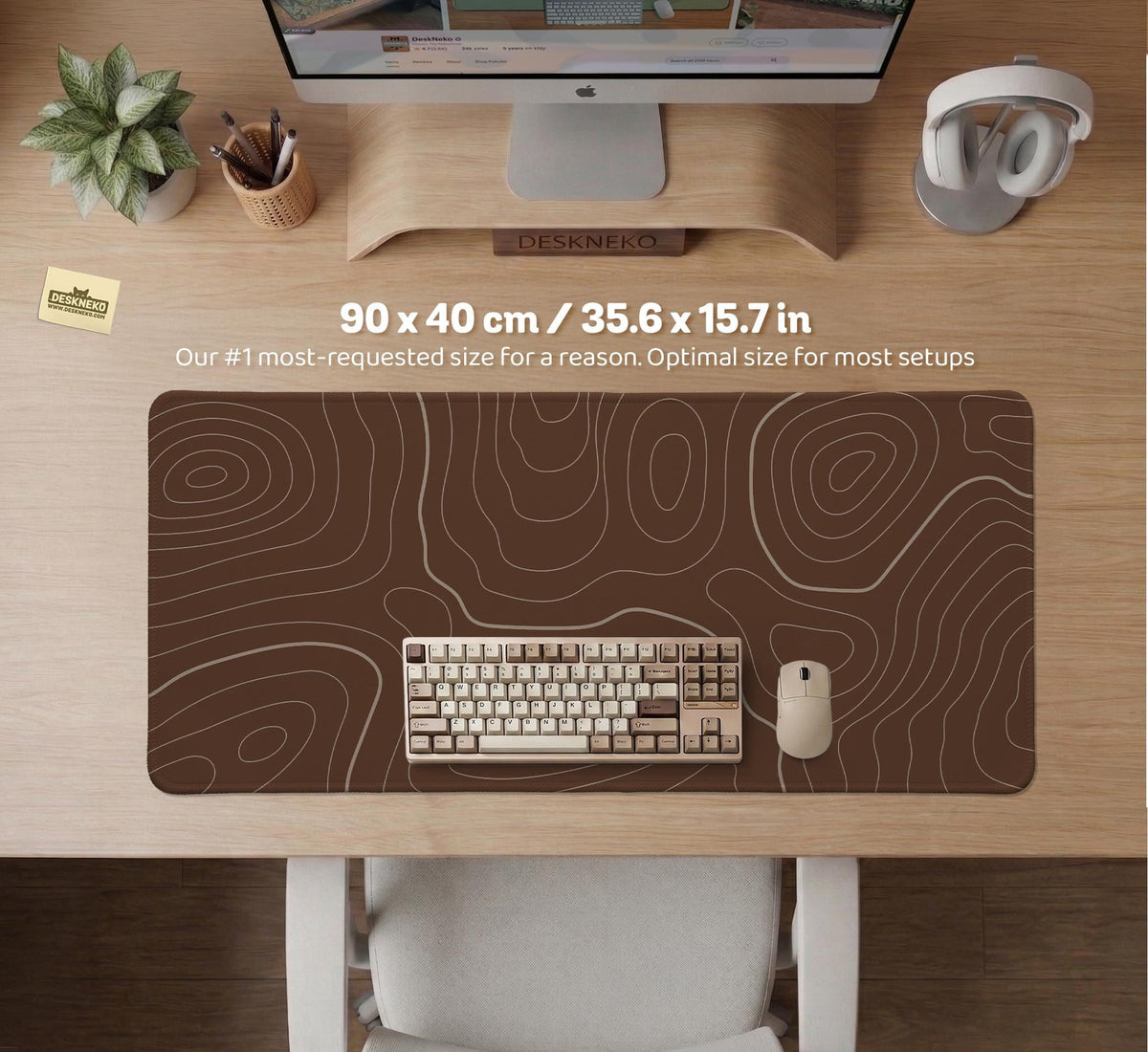 Brown desk mat with a repeating topographic contour line pattern in a neutral earth tone design.