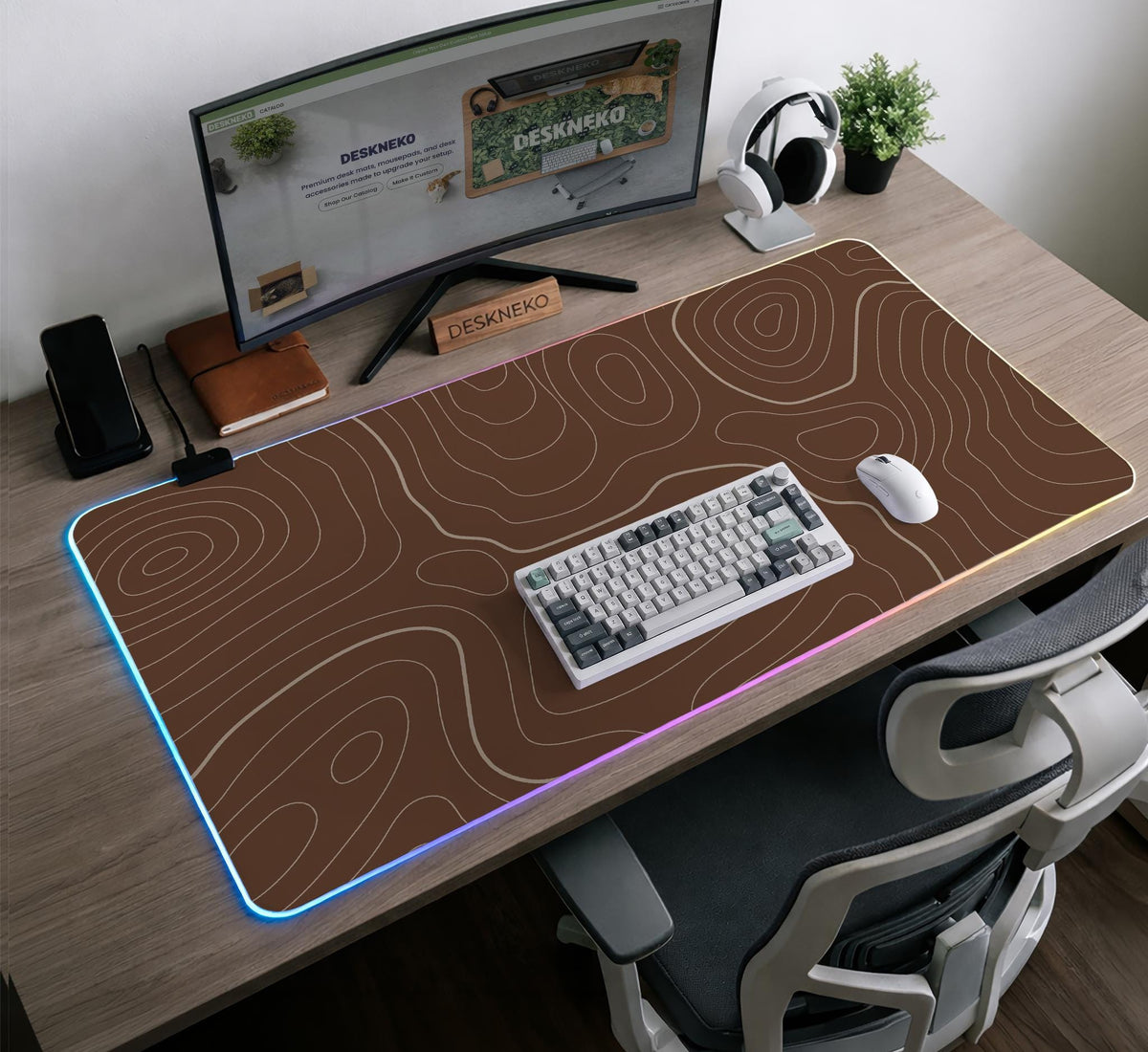 Brown desk mat with a repeating topographic contour line pattern in a neutral earth tone design.