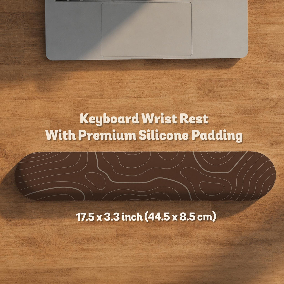 Brown desk mat with a repeating topographic contour line pattern in a neutral earth tone design.