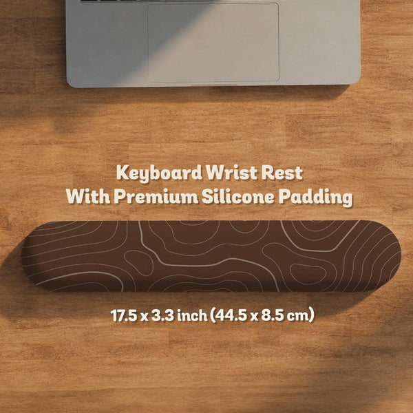 Brown desk mat with a repeating topographic contour line pattern in a neutral earth tone design.
