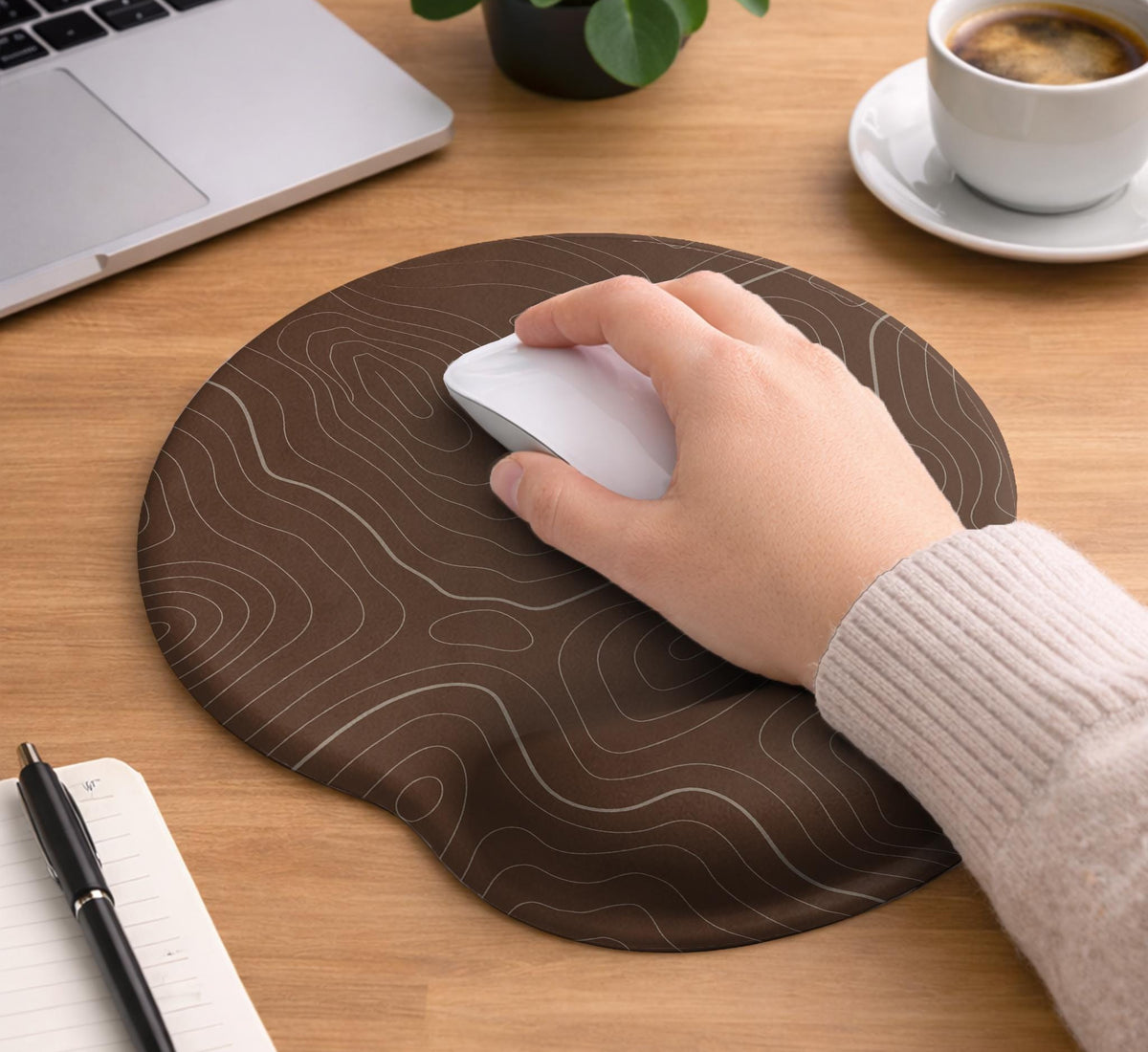 Brown mousepad and keyboard wrist rest with a topographic contour-line pattern.