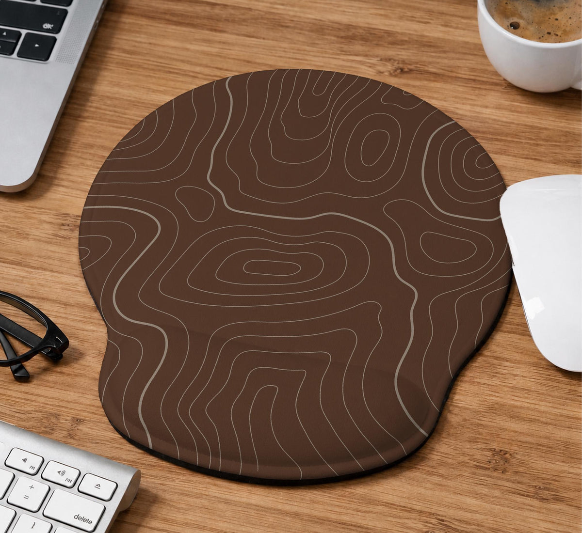 Brown mousepad and keyboard wrist rest with a topographic contour-line pattern.