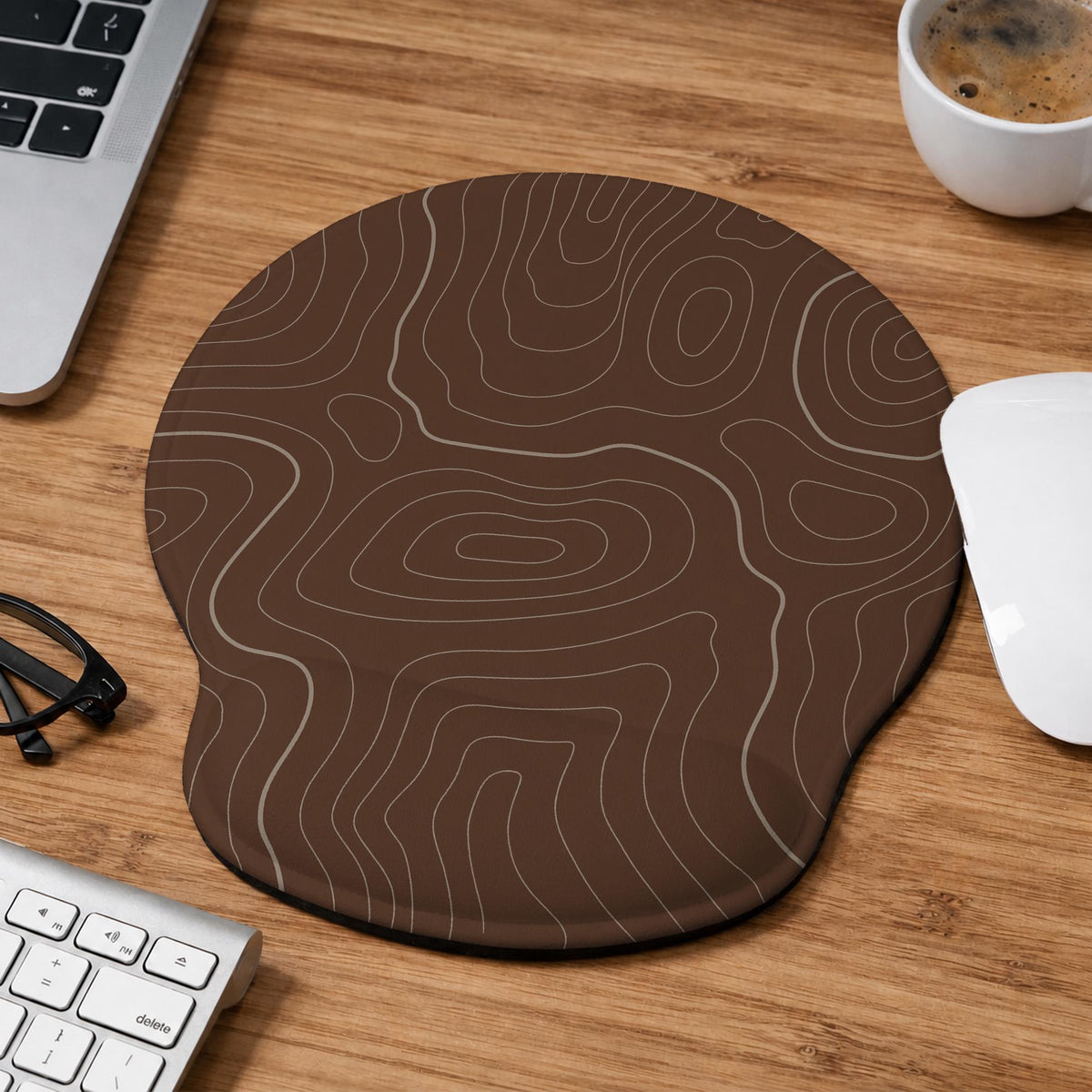 Brown mousepad and keyboard wrist rest with a topographic contour-line pattern.