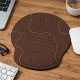 Brown mousepad and keyboard wrist rest with a topographic contour-line pattern.