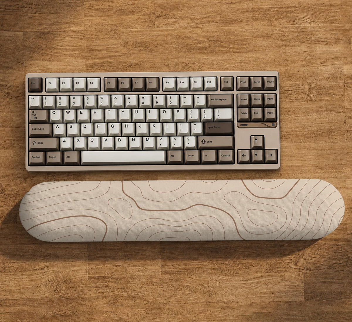 Beige mousepad and keyboard wrist rest with a topographic line pattern shown in a neutral desk setup.