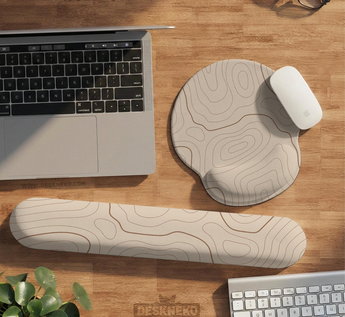 Beige mousepad and keyboard wrist rest with a topographic line pattern shown in a neutral desk setup.