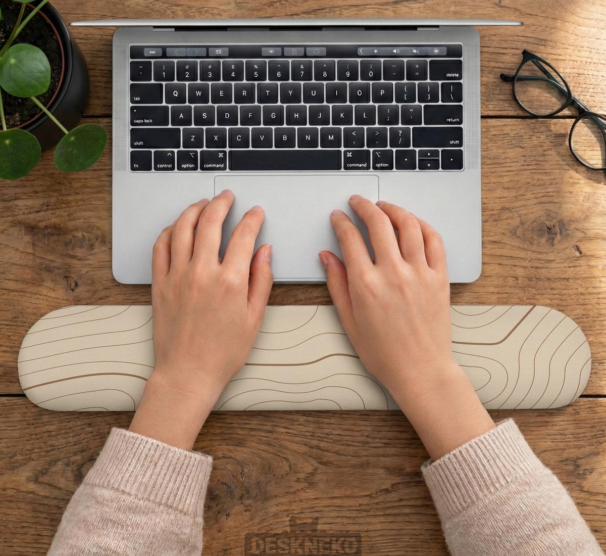 Beige mousepad and keyboard wrist rest with a topographic line pattern shown in a neutral desk setup.