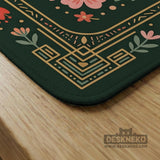 Dark green square mahjong mat with a golden spotted leopard in the center, surrounded by flowers, leafy stems, butterflies, and small star accents.