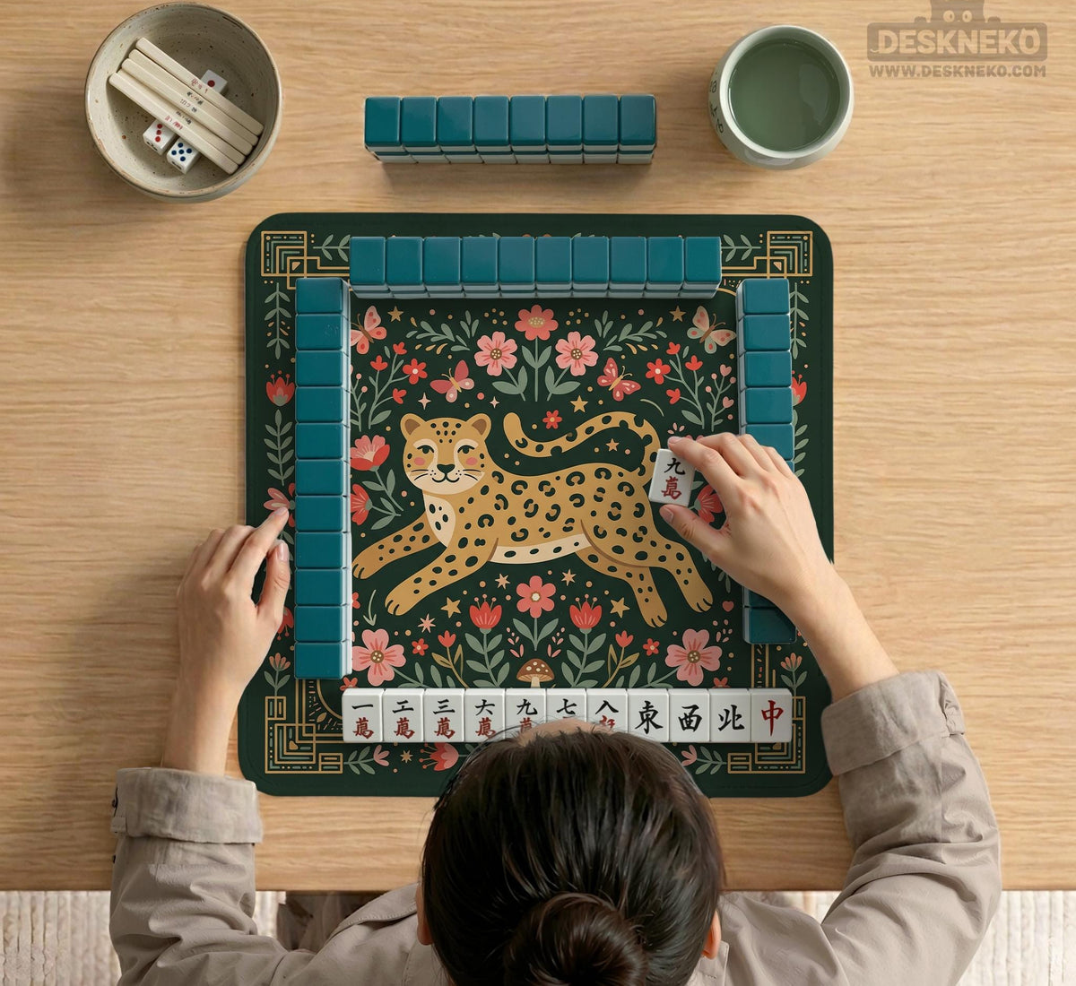 Dark green square mahjong mat with a golden spotted leopard in the center, surrounded by flowers, leafy stems, butterflies, and small star accents.