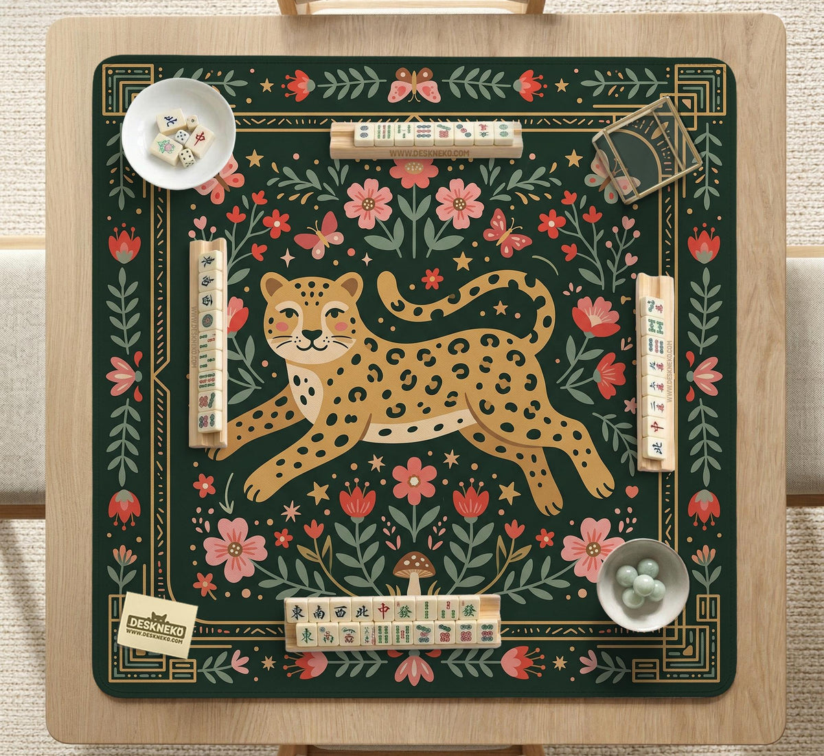 Dark green square mahjong mat with a golden spotted leopard in the center, surrounded by flowers, leafy stems, butterflies, and small star accents.