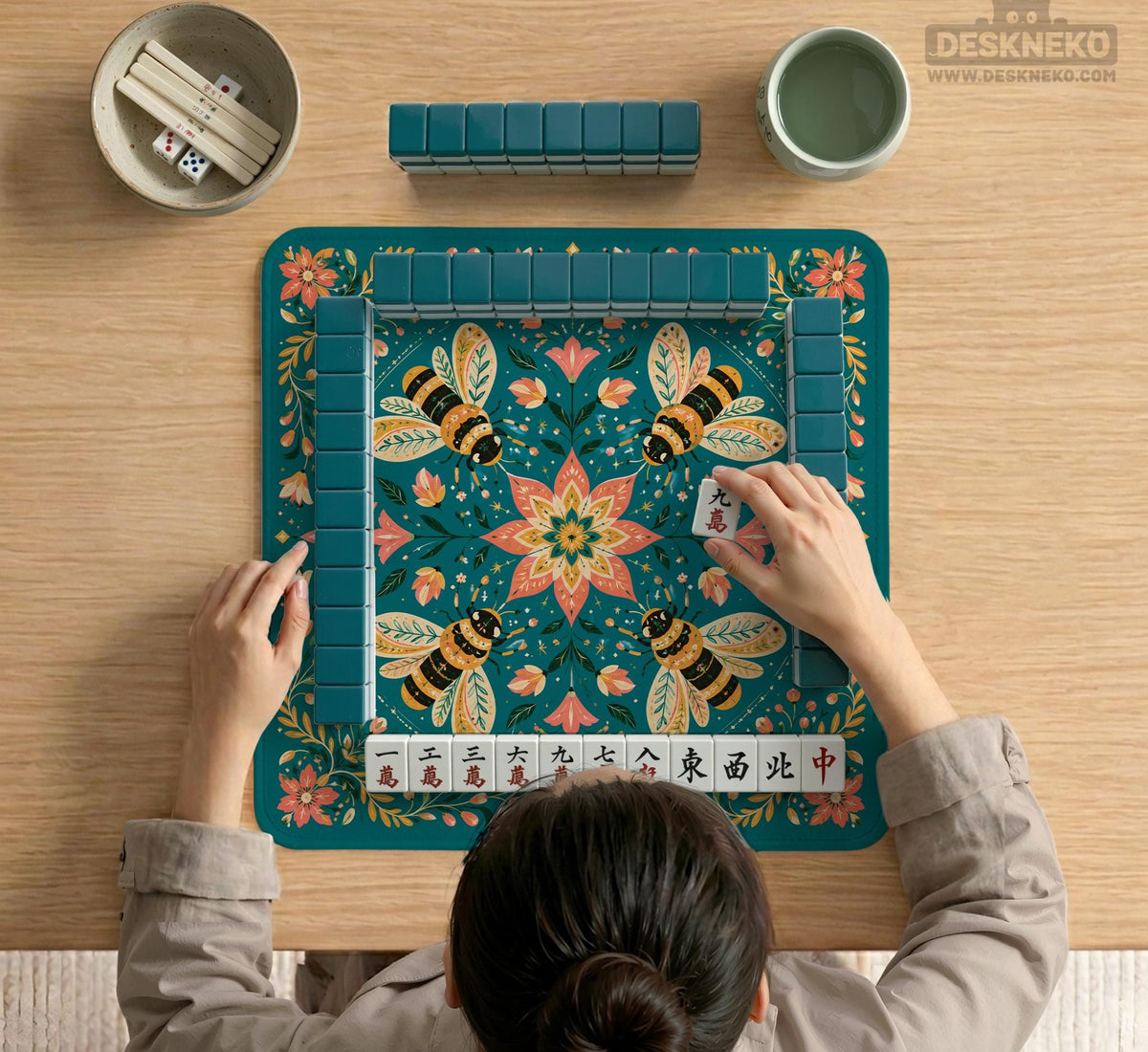 Green mahjong mat with a botanical bee and floral mandala design in teal, coral, cream, and gold.