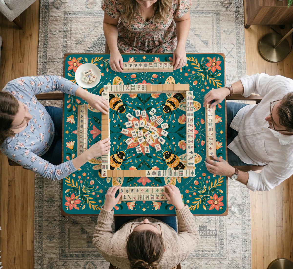Green mahjong mat with a botanical bee and floral mandala design in teal, coral, cream, and gold.