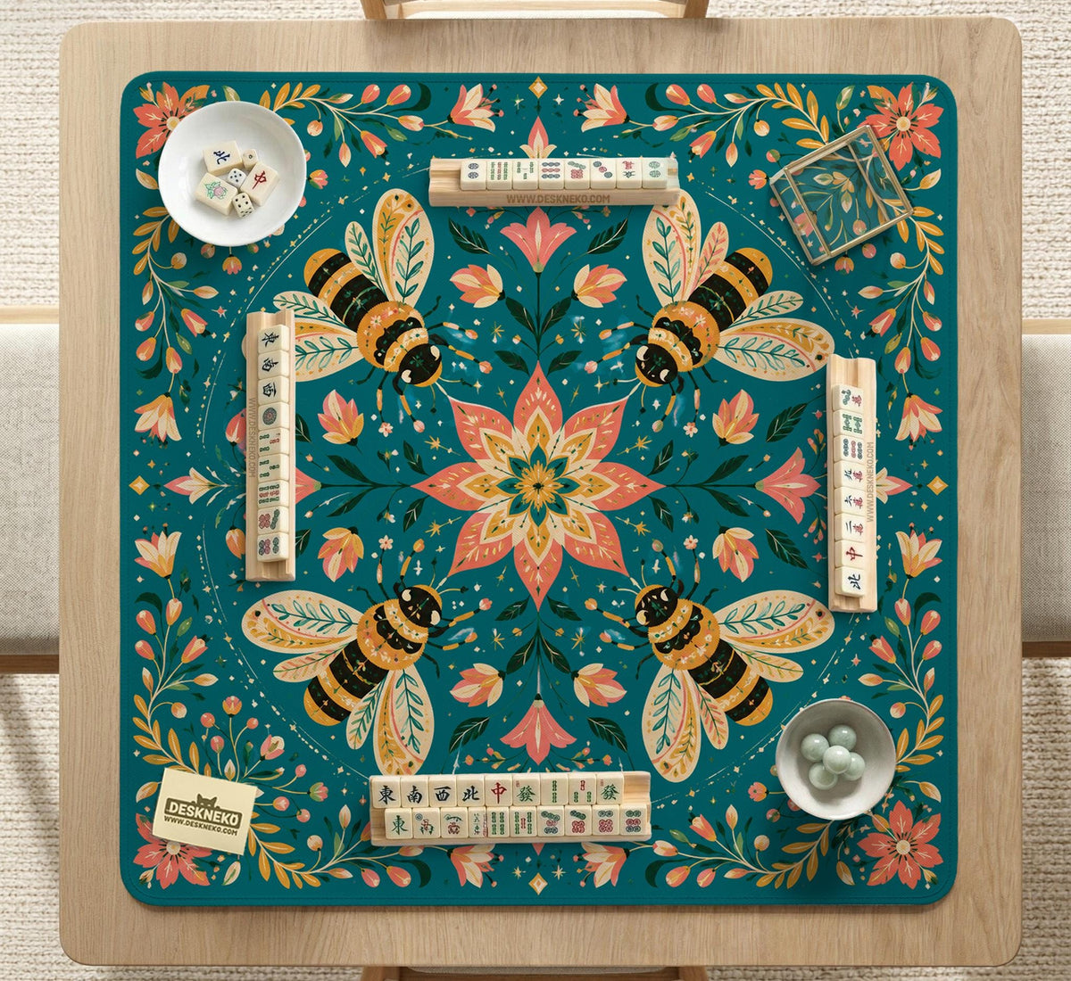 Green mahjong mat with a botanical bee and floral mandala design in teal, coral, cream, and gold.
