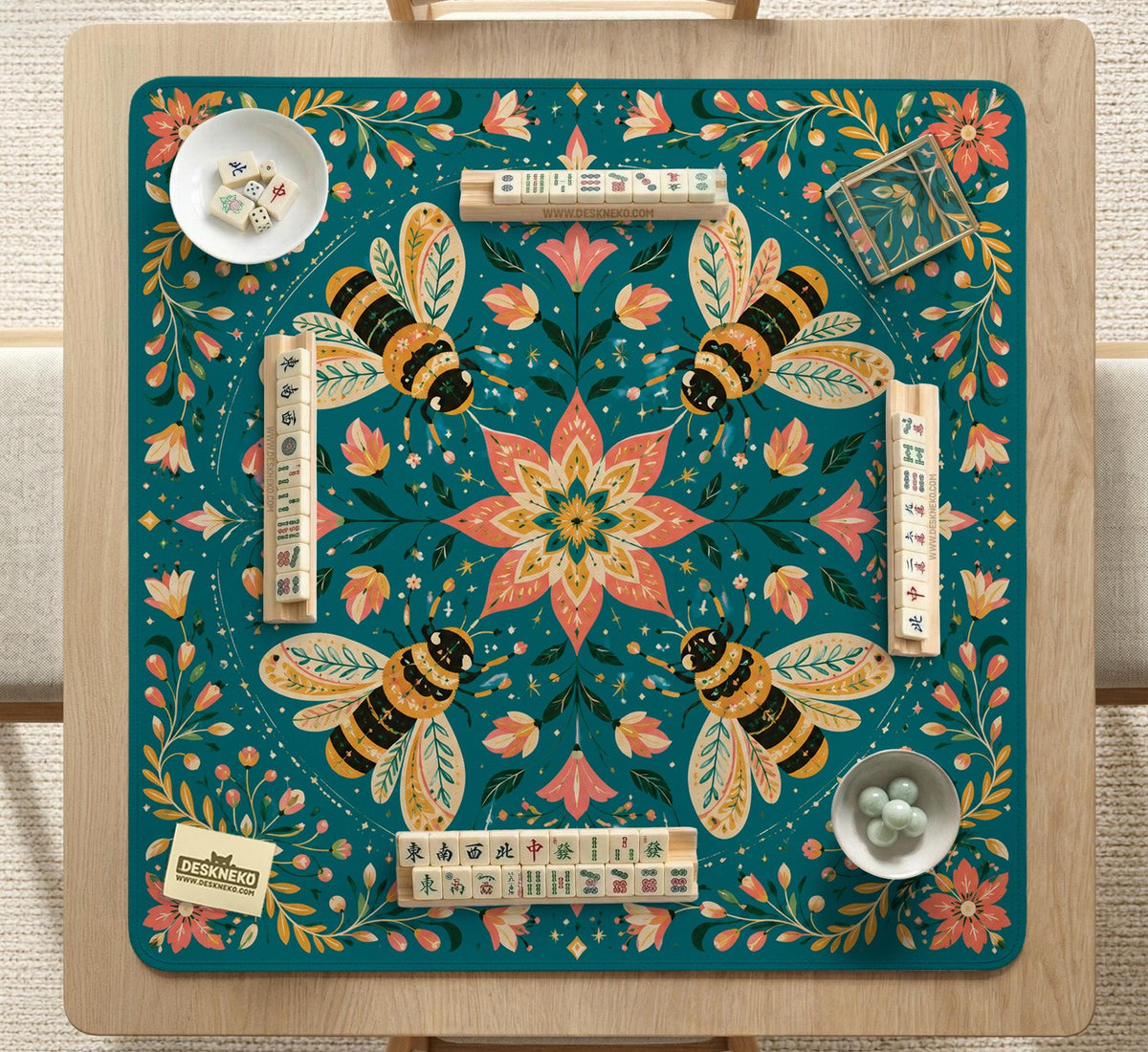 Green mahjong mat with a botanical bee and floral mandala design in teal, coral, cream, and gold.