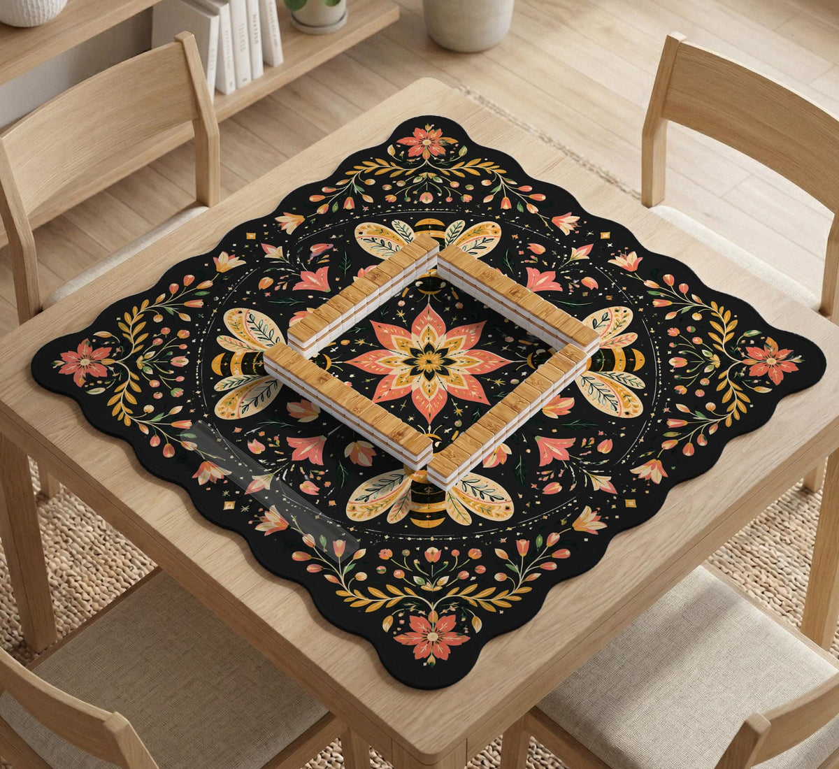 Black mahjong mat with a symmetrical botanical design, coral flowers, golden leaves, and small bees.