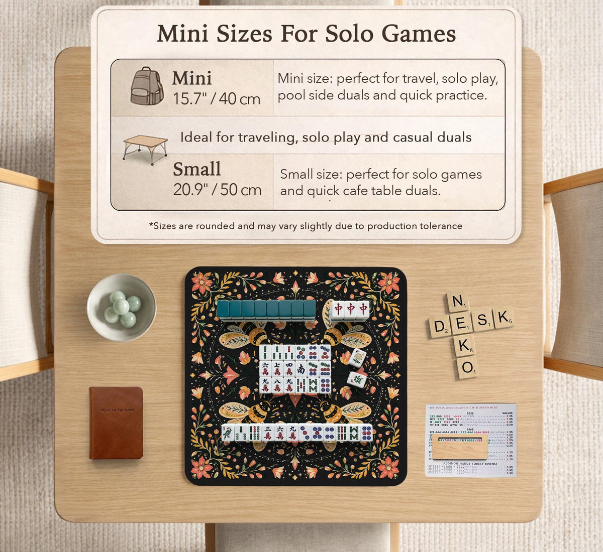 Black mahjong mat with a symmetrical botanical design, coral flowers, golden leaves, and small bees.