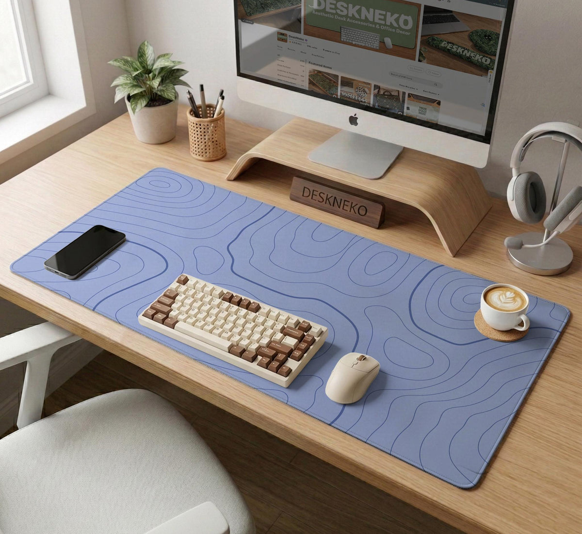 A periwinkle deskmat with thin blue contour lines printed across the surface.