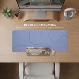A periwinkle deskmat with thin blue contour lines printed across the surface.