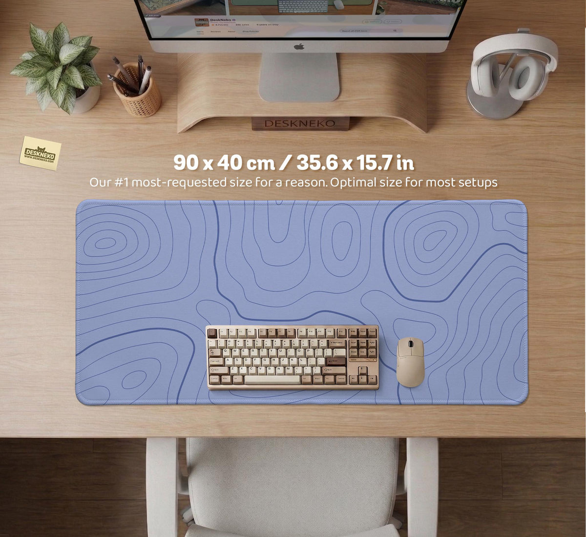A periwinkle deskmat with thin blue contour lines printed across the surface.