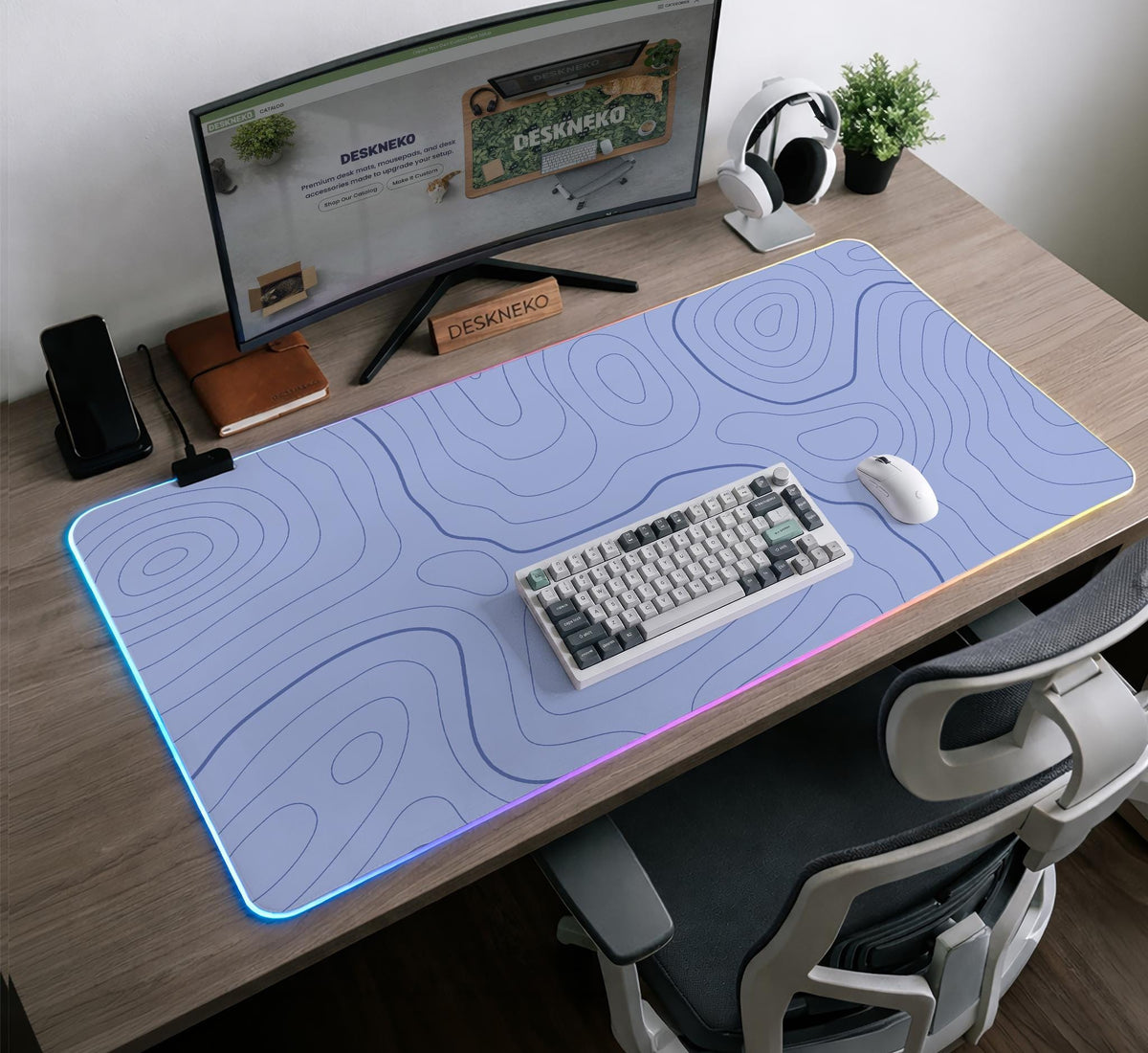A periwinkle deskmat with thin blue contour lines printed across the surface.