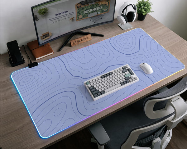 A pastel blue mousepad with an abstract topographic contour line pattern.